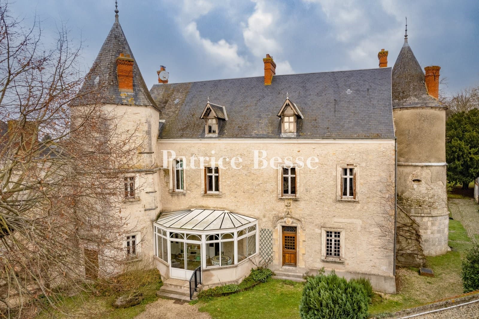 Historic Château With Hexagonal Tower And Wooded Grounds